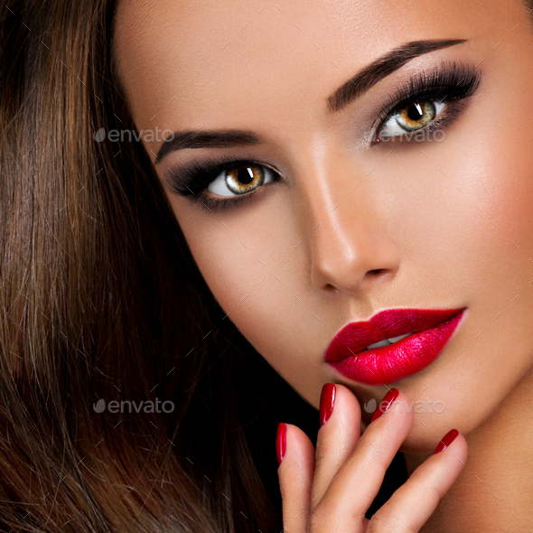 seductive woman with dark brown eye makeup and bright red lips a Stock